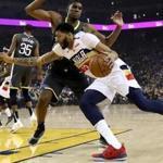 OAKLAND, CALIFORNIA - JANUARY 16: Anthony Davis #23 of the New Orleans Pelicans drives on Kevon Looney #5 of the Golden State Warriors at ORACLE Arena on January 16, 2019 in Oakland, California. NOTE TO USER: User expressly acknowledges and agrees that, by downloading and or using this photograph, User is consenting to the terms and conditions of the Getty Images License Agreement. (Photo by Ezra Shaw/Getty Images)