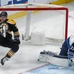 01-29-19: Boston, MA: The Bruins Jake DeBrusk (left) sails backwards into the net in front of Jets goalie Connor Hellebuyck (right), knocking it off the post in second period action. The Boston Bruins hosted the Winnipeg Jets in a regular season NHL hockey game at the TD Garden. (Jim Davis /Globe Staff)