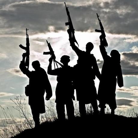 Silhouette of several muslim militants with rifles
