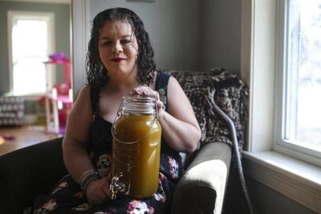 Dedham, MA--02/01/2019--Joanna Varner, 36, of Weymouth, poses for a portrait with her marijuana-infused mango tea on Friday afternoon. Varner is a medical marijuana patient who dreams of starting a business -- Ladies Lifted Kitchen -- making organic, gourmet cannabis-infused cookies, brownies, granola, and tea. (Nathan Klima for the Boston Globe) Topic: 03illicitpot Reporter:
