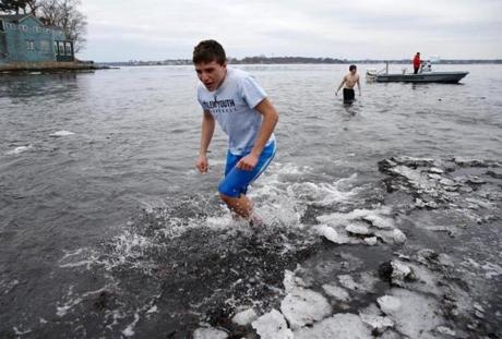 Participants in a polar plunge in Beverly quickly ran back to shore Sunday.
