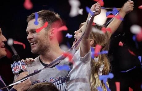 SUPER BOWL LIII SLIDER Atlanta, GA - 2/03/2019 - (4th quarter and end of game ceremony) New England Patriots quarterback Tom Brady (12) with daughter Vivian (please check spelling) on podium with Jim Nance after the game. New England Patriots vs. LA Rams in Super Bowl LIII at Mercedes-Benz Stadium in Atlanta, GA. (Barry Chin/Globe Staff), Section: Sports, Reporter: James M. McBride, Topic: 04Super Bowl, LOID: 8.5.296042561.
