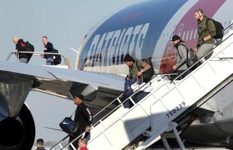 Players, including the injured Patrick Chung, center, stepped off the Patriots plane. 
