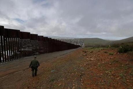 Border Patrol agent Vincent Pirro looks on near a border wall that separates the cities of Tijuana, Mexico, and San Diego, Tuesday, Feb. 5, 2019, in San Diego. President Donald Trump is expected to speak about funding for a wall along the U.S.-Mexico border during his State of the Union address Tuesday. (AP Photo/Gregory Bull)
