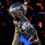 ATLANTA, GA - FEBRUARY 03: A detail of a New England Patriots player raising the Vince Lombardi Trophy after the Patriots defeat the Los Angeles Rams 13-3 during Super Bowl LIII at Mercedes-Benz Stadium on February 3, 2019 in Atlanta, Georgia. (Photo by Kevin C. Cox/Getty Images)