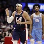 Los Angeles Clippers' Tobias Harris, left, signals after making a three-point basket in front of Sacramento Kings' Marvin Bagley III (35) during the second half of an NBA basketball game Sunday, Jan. 27, 2019, in Los Angeles. (AP Photo/Marcio Jose Sanchez)