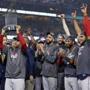 Los Angeles, CA: 10-28-18: Manager Alex Cora hoists the trophy as the Red Sox celebrate their World Series victory. David Price is in the middle. The Boston Red Sox visited the Los Angeles Dodgers in Game Five of the World Series at Dodger Stadium. (Jim Davis/Globe Staff)