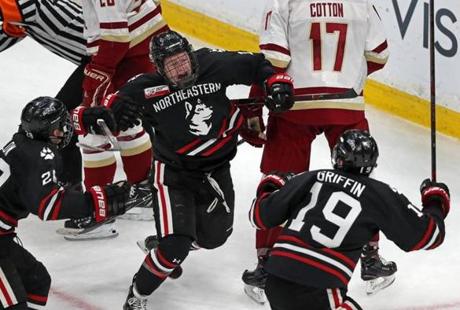2-11-19 Boston, MA: Northeastern's Austn Plevy (14,center) erupts in celebration after he put th epuck behind BC goalie Joseph Woll (not pictured) to give the Huskies a 1-0 first period lead. Northeastern University met Boston College in the Beanpot\Championship Game at the TD Garden. (Jim Davis /Globe Staff)
