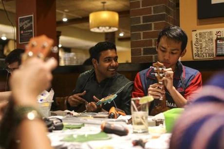 Thursday at Bertucci?s in Kendall Square was ukulele-building night, an event put on by Somerville-based Yaymakers. The participants included Rajesh Sridhar (left) and Jed Tranate. 
