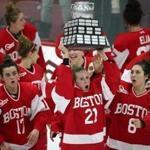 Cambridge MA 2/12/19 Boston University Abbbey Stanley (21) and her teammates celebrate with the Beanpot Trophy after they defeated Harvard 3-2 during the overtime period of the Women's Beanpot Final at Harvard's Bright-Landry Hockey Center. (photo by Matthew J. Lee/Globe staff) topic: reporter: 