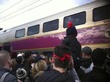 2/5/19 -- MANSFIELD -- Crowded commuter rail filled to capacity with Patriot's fans, does not pick up passengers at the Mansfield train station where hundreds wait on the platform, hoping to get to the Patriots victory parade early Tuesday morning. (Leanne Burden Seidel /Globe staff) boston globe super bowl victory parade
