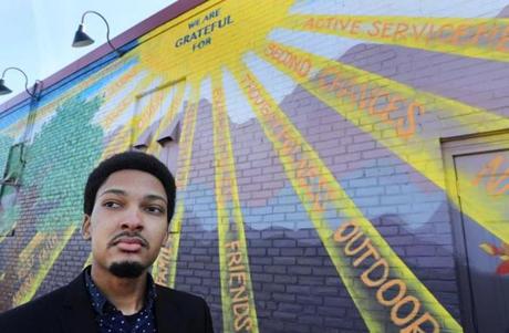 Jordan Thompson, 20, is one of 22 men from around the country picked to participate in Barack Obama's My Brother's Keeper summit in Oakland, Calif. He poses in Nashua, N.H., next to a mural near City Hall created by PositiveStreetArt.org. 
