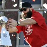 A bearded Julian Edelman reached for the Lombardo Trophy during last week?s parade through downtown Boston.