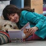 Vivian cuddles with Oscar as she reads to him at the Epstein Hillel School in Marblehead.