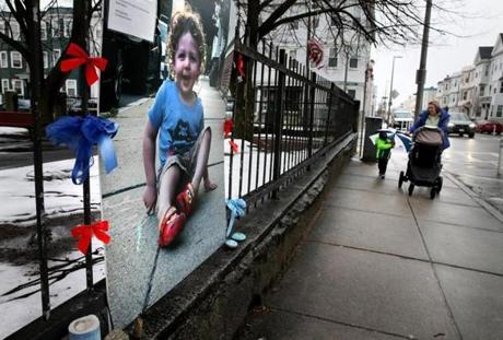 Close to the crash site, nearly seven months later, a large picture of Colin remains affixed to an iron fence in front of the Monsignor John T. Powers Apartments in South Boston.
