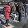 CAMBRIDGE, MA - 1/25/2019: Pedestrians cross Broadway in Cambridge. Cambridge has six subway stops, several major bus lines, and bike lanes everywhere. It?s minutes from downtown Boston, densely packed over just 6.4 square miles, and has enacted several public policies aimed at severely reducing carbon emissions. Yet even Cambridge can?t seem to get its residents to give up their cars ? or, at least, not as quickly as officials would like. (David L Ryan/Globe Staff ) SECTION: METRO TOPIC 