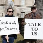 Protestors in Washington, D.C., on Saturday with signs about the defrocking of former US cardinal Theodore McCarrick.