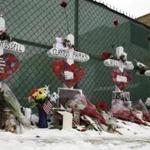 Five crosses set near the Henry Pratt Co. warehouse in Aurora, Ill., on Sunday bore the names of the people who died in a shooting there Friday.