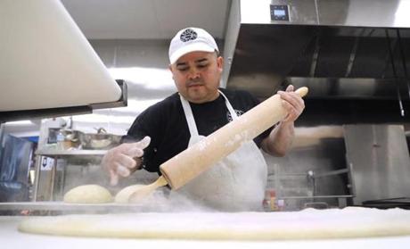 Saugus, MA - 2/13/19 Head baker Rigoberto Cartagena (cq) flours dough on the sheeter. Kane's Donuts (cq) is opening a new location in Saugus, near the orange dinosaur. (The shop and the dinosaur date from the 1950s.) Co-owner and president Paul Delios (cq) said the expected hard opening will be by March 1. Photo by Pat Greenhouse/Globe Staff Topic: Kane's Reporter: Jon Chesto
