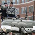 Clarence Smoyer waved as he rode in a Sherman tank to the Charlestown Navy Yard on Wednesday. 