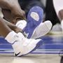 Duke's Zion Williamson sat on the floor following an injury caused when his shoe split during play. 