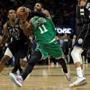 Boston Celtics' Kyrie Irving (11) drives between Milwaukee Bucks' Eric Bledsoe (6) and Giannis Antetokounmpo during the second half of an NBA basketball game Thursday, Feb. 21, 2019, in Milwaukee. (AP Photo/Aaron Gash)