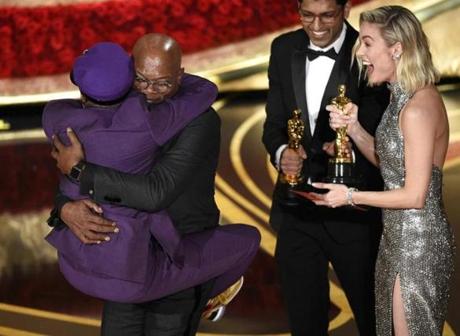 Spike Lee (left) leaped into the arms of friend Samuel L. Jackson after winning the Oscar for best adapted screenplay in 