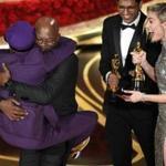 Spike Lee (left) leaped into the arms of friend Samuel L. Jackson after winning the Oscar for best adapted screenplay in 