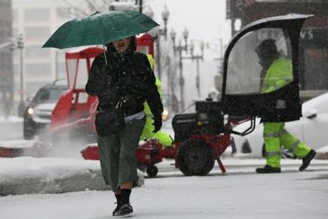 BOSTON, MA - March 02, 2019: - A woman protects herself from the son while walking on Berkeley Street in Boston, MA on March 02, 2019. Saturday morning?s storm, which is set to drop up to 4 inches of snow on Boston, will be quickly followed by another storm Sunday night. The National Weather Service has issued a winter weather advisory until 7 p.m. Saturday for eastern and central parts of the state, as well as the South Shore and Cape and Islands. Western Massachusetts is under a winter storm watch until 7 p.m. as well.(Craig F. Walker/Globe Staff) section: Metro reporter: 
