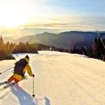 A skiier who is far more skilled than the author heads into the sunrise at Stowe Mountain Resort.