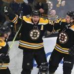 Boston-03/07/19 Boston Bruins vs Florida Panthers- Bruins Patrice Bergeron celebrates his 3rd period goal to tie the game, 2-2, as he is congratulated by John Moore(left) and Charlie McAvoy. Photo by John Tlumacki/Globe Staff(sports)