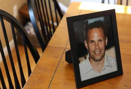 East Bridgewater, MA, 03/7/2019 -- Chris McCallum, (C) is seen in a family photo on the kitchen table inside his home. (Jessica Rinaldi/Globe Staff) Topic: 08quincy Reporter: 

