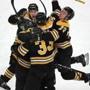 Patrice Bergeron is engulfed by happy Bruins teammates after his tiebreaking goal in the final seconds. 