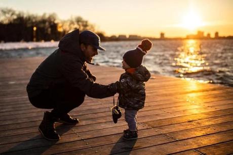 03/11/2019 BOSTON, MA Brendan Moses (cq) plays with his son Liam (cq) 17 months, during the last hour of sunlight on the Charles River Esplanade in Boston. (Aram Boghosian for The Boston Globe)
