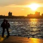 03/11/2019 BOSTON, MA Hamit Sahin (cq) (left) kisses his wife Laura Chambre (cq) of Boston, during the last hour of sunlight on the Charles River Esplanade in Boston. (Aram Boghosian for The Boston Globe)