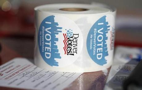 FILE--In this Tuesday, Nov. 6, 2018, file photograph, a roll of stickers sits on a table to be handed out by election judges as voters deposit their ballots at the Denver Elections Division drop off location in front of the City/County Building in Denver. Colorado's Democrat-controlled Legislature has approved a bill Thursday, Feb 21, 2019, to join other states in casting their presidential electoral votes for the winner of the national popular vote. (AP Photo/David Zalubowski, File)
