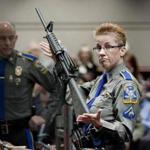 Firearms training unit Detective Barbara J. Mattson held a Bushmaster AR-15 rifle, the same make and model used by Adam Lanza in the 2012 Sandy Hook School shooting. 