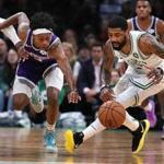 Boston-03/14/19 Bostn Celtics vs Kings -Celtics Kyrie Irving gets possession of the ball in the 4th qtr as Kings De'Aaron Fox chases after him. Photo by John Tlumacki/Globe Staff(sports)