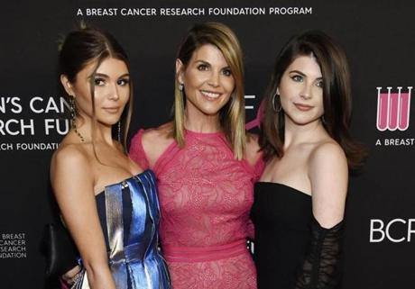 FILE - In this Feb. 28, 2019 file photo, actress Lori Loughlin, center, poses with daughters Olivia Jade Giannulli, left, and Isabella Rose Giannulli at the 2019 
