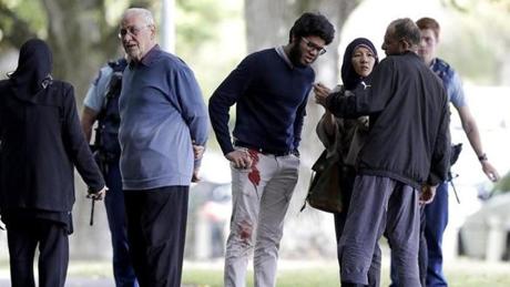 MOSQUE SHOOTING SLIDER People stand across the road from a mosque in central Christchurch, New Zealand, Friday, March 15, 2019. A witness says a number of people have been killed in a mass shooting at a mosque in the New Zealand city of Christchurch; police urge people to stay indoors.(AP Photo/Mark Baker)
