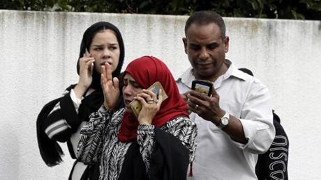 MOSQUE SHOOTING SLIDER People wait outside a mosque in central Christchurch, New Zealand, Friday, March 15, 2019. Many people were killed in a mass shooting at a mosque in the New Zealand city of Christchurch on Friday, a witness said. Police have not yet described the scale of the shooting but urged people in central Christchurch to stay indoors. (AP Photo/Mark Baker)
