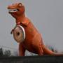 The big orange dinosaur in Saugus is now holding a giant replica doughnut ? an advertisement for a nearby shop. 