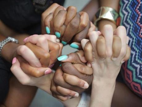Survivors of sex trafficking join hands in support of one another.
