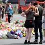 Residents pay their respects by placing flowers for the victims of the mosques attacks in Christchurch on March 16, 2019.