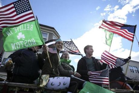 Boston, MA--03/17/2019--People in the St. Patrick's Day parade wave to the crowd while holding flags on Sunday afternoon. (Nathan Klima for The Boston Globe) Topic: 18parade Reporter:
