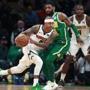 3-18-19: Boston, MA:Former Celtics guard Isaiah Thomas, left, now a member of the Nuggets, but sporting green sneakers, is pictured as he drives on the man he was traded for, the Celtics Kyrie Irving in the first quarter. The Boston Celtics hosted the Denver Nuggets in a regular season NBA basketball game at the TD Garden. (Jim Davis /Globe Staff).