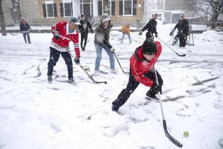 Ware Cady?s son, Ware Jr. (right), made a play on the ball during the street hockey game on Chestnut Street on March 10.
