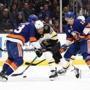 UNIONDALE, NEW YORK - MARCH 19: David Pastrnak #88 of the Boston Bruins collides with Adam Pelech #3 of the New York Islanders during their game at NYCB Live's Nassau Coliseum on March 19, 2019 in Uniondale, New York. (Photo by Al Bello/Getty Images)