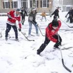 Ware Cady?s son, Ware Jr. (right), made a play on the ball during the street hockey game on Chestnut Street on March 10.