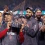 Los Angeles, CA: 10-28-18: Manager Alex Cora (left) hoists the trophy as (left to right) David Price, Rick Porcello, Chris Sale and Eduardo Nunez look on while the Red Sox celebrate their World Series victory. The Boston Red Sox visited the Los Angeles Dodgers in Game Five of the World Series at Dodger Stadium. (Jim Davis/Globe Staff)